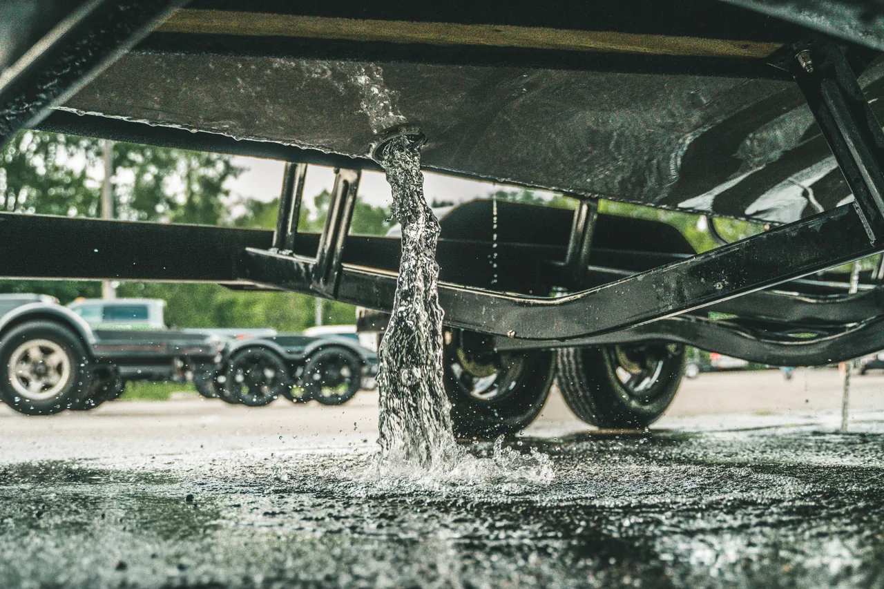 Water draining from an Anthem hull on a trailer